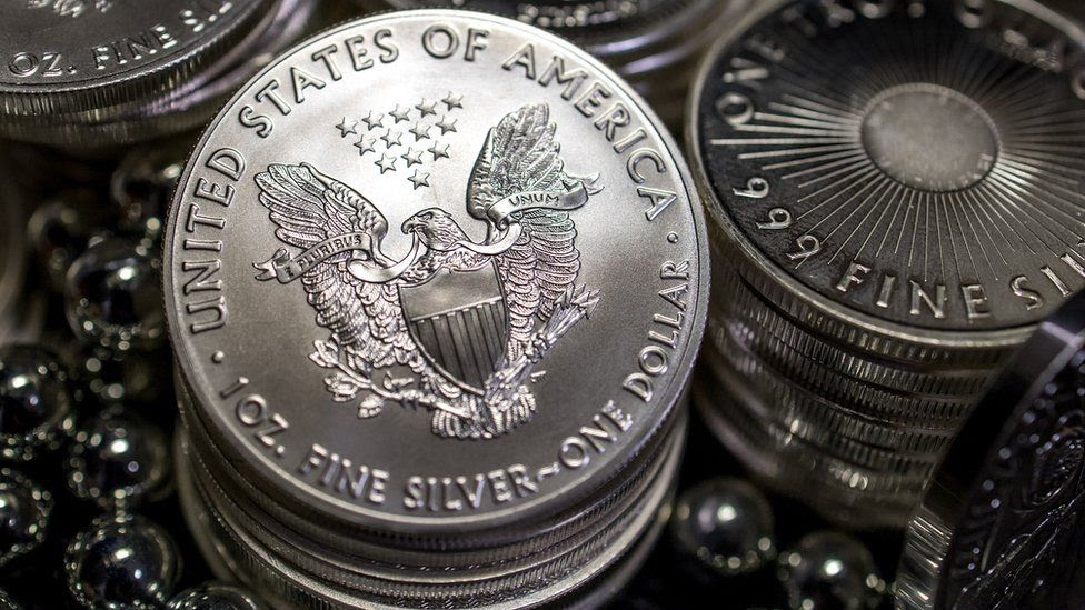 Multiple stacks of the 1 ounce 2016 American Eagle US one dollar coin.