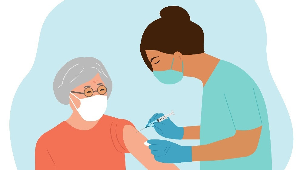 medical professional administering a vaccine to an older woman