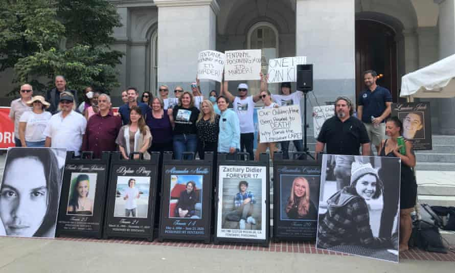 people hold signs and portraits