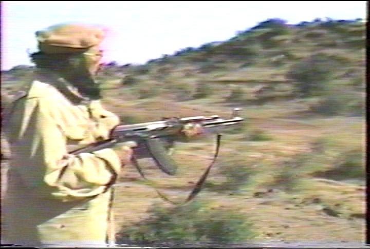 The spiritual leader of Muslims of America is Sheikh Mubarik Gilani, shown here shooting a rifle in a Soldiers of Allah recruiting video.