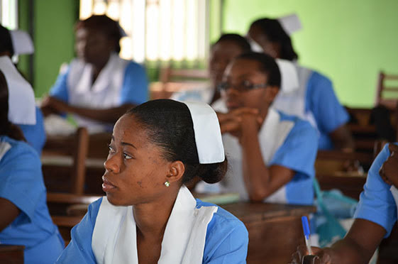 Nursing students listen to a lecture.