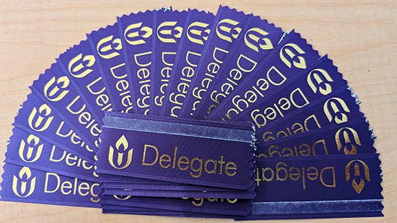 a stack of purple GA delegate ribbons