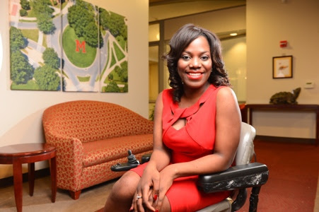 Ola, a 2015 "No Boundaries" participant, wears a red dress and poses in her wheelchair