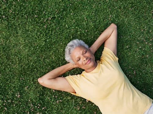 Woman Relaxes on Grass