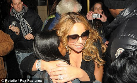Mariah embracing a fan who greeted her as she arrived at London's Dorchester Hotel on Wednesday