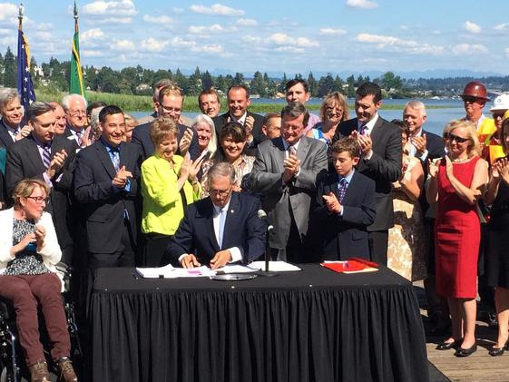 Gov. Jay Inslee signing the transportation bill