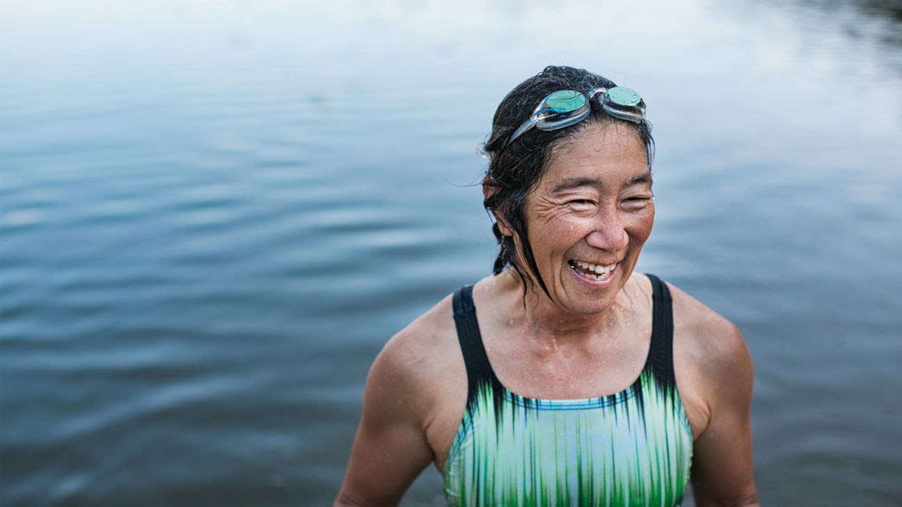 A woman in a swimsuit standing in a lake.