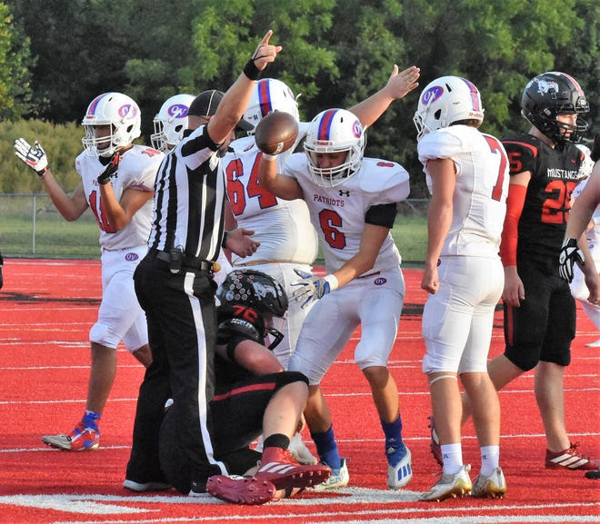 Owen Valley's Seth Brewster comes up with the loose ball after an Edgewood fumble, one of the Mustangs' five turnovers.