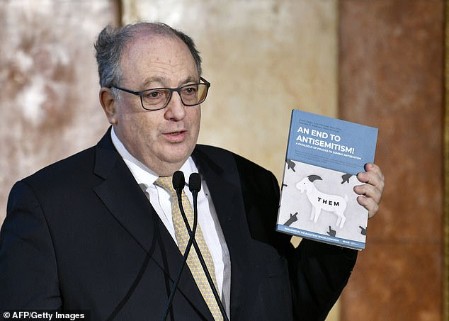 Ariel Muzicant, Vice-President of the European Jewish Congress, and co-author of the new document holds it up, showing the title 'An End to Antisemitism! A Catalogue of Policies to Combat Antisemitism'