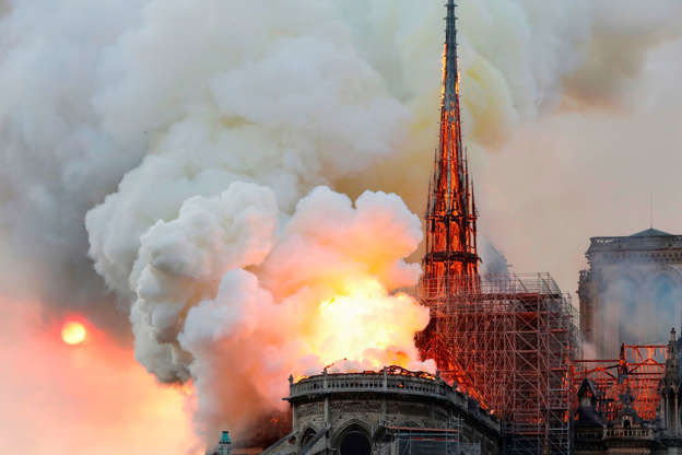 Slide 21 of 31: TOPSHOT - Smoke and flames rise during a fire at the landmark Notre-Dame Cathedral in central Paris on April 15, 2019, potentially involving renovation works being carried out at the site, the fire service said. - A major fire broke out at the landmark Notre-Dame Cathedral in central Paris sending flames and huge clouds of grey smoke billowing into the sky, the fire service said. The flames and smoke plumed from the spire and roof of the gothic cathedral, visited by millions of people a year, where renovations are currently underway. (Photo by FRANCOIS GUILLOT / AFP) (Photo credit should read FRANCOIS GUILLOT/AFP/Getty Images)