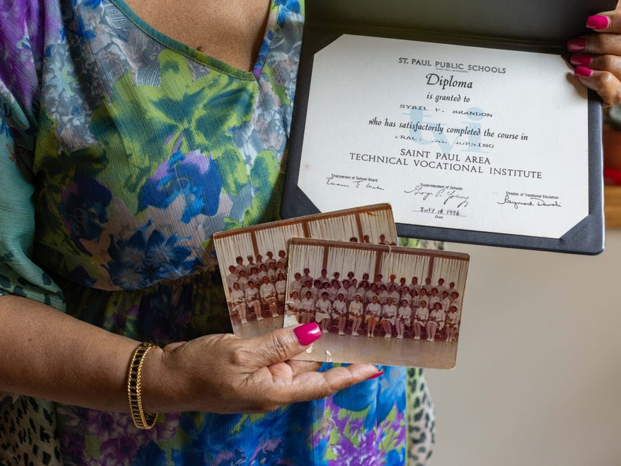 Sybil Garbow shows a nursing diploma and photos from her time in school.