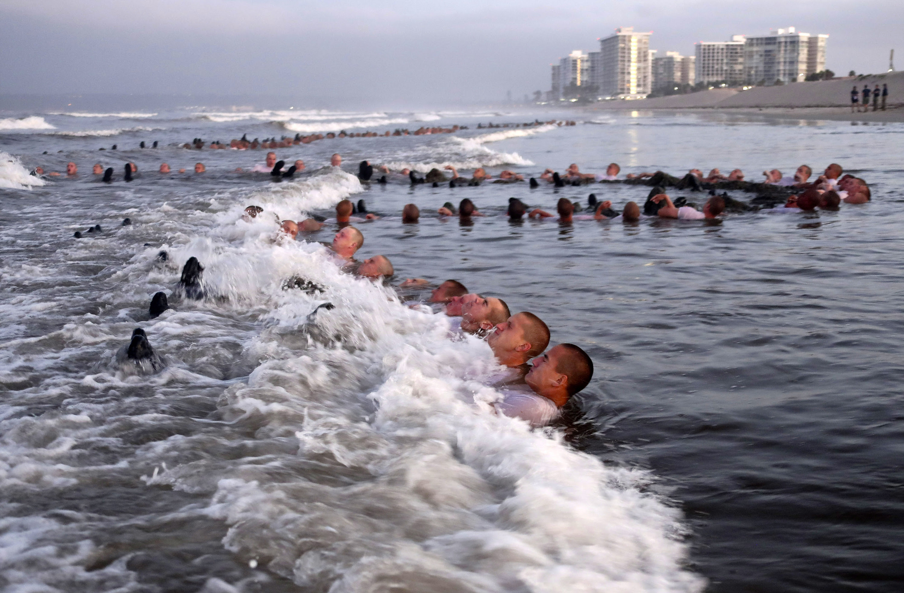 U.S. Navy SEAL candidates, participate in ''surf immersion'' during Basic Underwater Demolition/SEAL (BUD/S) training at the Naval Special Warfare (NSW) Center in Coronado, Calif., on May 4, 2020.