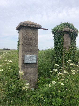 The gate posts that stood at the entrance of an S.S. concentration camp on the island of Alderney, one of the Channel Islands, during World War II. by the Forward
			