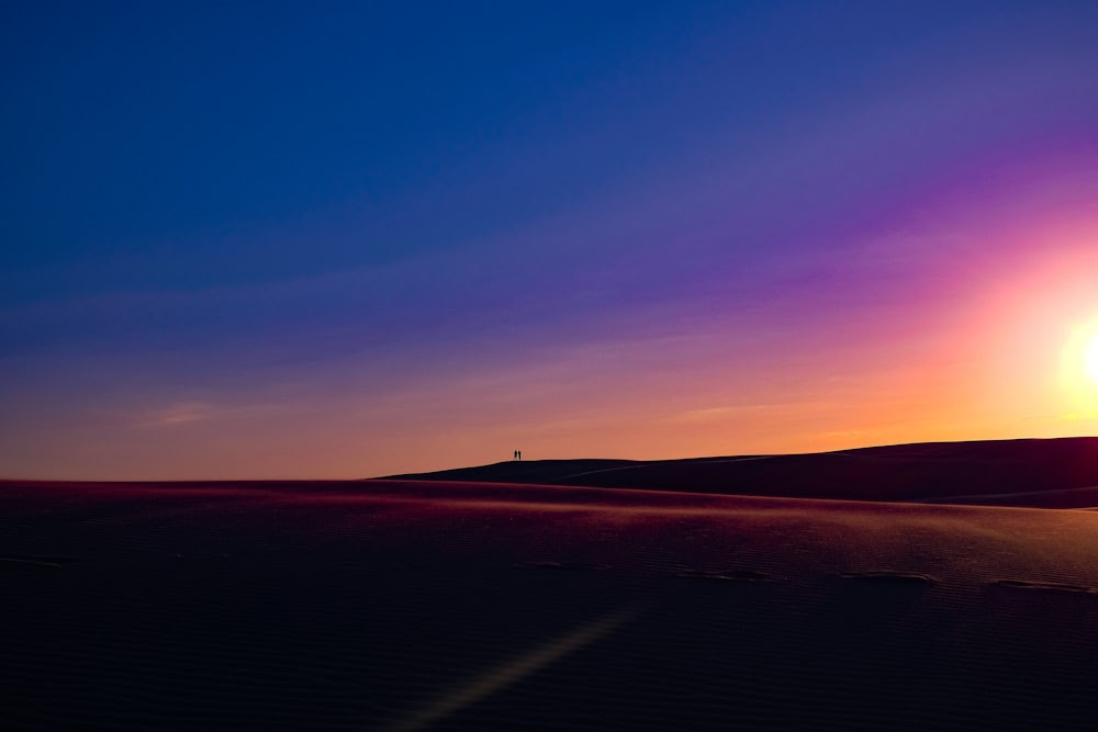 silhouette sur deux personnes sur la dune