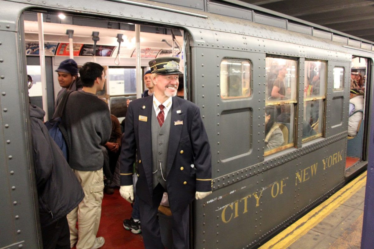 Conductor in costume with vintage 1930s train car